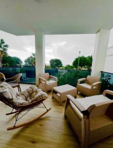 a living room with furniture and a large window at Villa Fibonacci - Beachfront Lalez Bay Durres in Draç