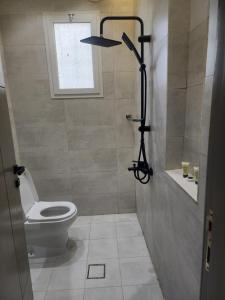 a bathroom with a toilet and a window at ليالي القمر 2 in Sūq ath Thalut +13 photos
