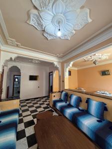 a living room with a couch and a ceiling at casa chawni in Chefchaouen