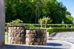a stone planter with a tree in it at Apartments Ivo Bozinovic in Tivat