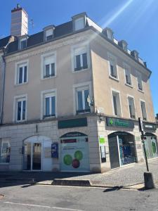 a large building on the corner of a street at Spacieux spa et sauna in Bourges