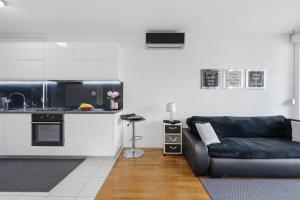 a living room with a couch and a kitchen at Apartman Tonka in Šibenik +19 photos