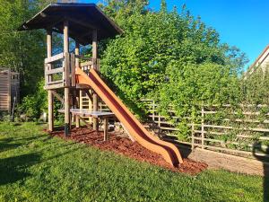 a wooden playground with a slide and a bench at Ferienwohnung Schmuckkästchen in Calw