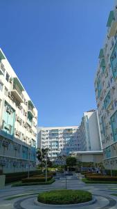 two tall buildings in a city with a parking lot at Keyspace condotel in Piapi
