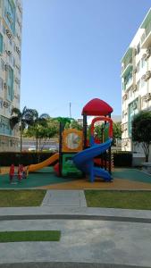 a playground with a slide in a park at Keyspace condotel in Piapi