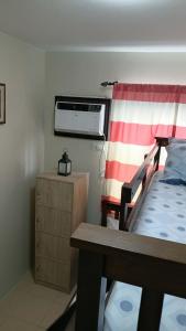 a bedroom with a bunk bed and a dresser at Keyspace condotel in Piapi +28 photos