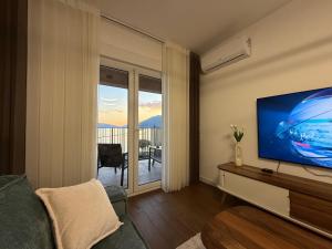 a living room with a large flat screen tv at Seafront apartment Tivat in Donja Lastva