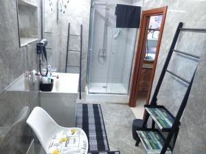 a bathroom with a shower and a toilet and a sink at Sandra B&B in Luz de Tavira +21 photos