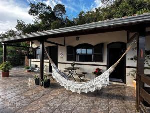 a patio with a hammock outside of a house at Recanto Divô e Divó in Ouro Preto +14 photos