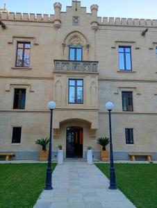 a building with two street lights in front of it at Villa Alliata Relais & Spa in Palermo