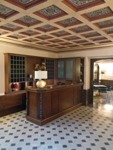 a large room with a coffered ceiling and a table at Villa Alliata Relais & Spa in Palermo