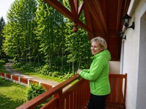 a woman standing on the balcony of a house at Penzion Vital in Liberec