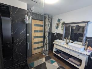 a bathroom with two sinks and a shower at Chambres d'hotes la forêt in Longwy +15 photos