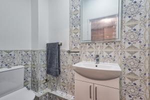 a bathroom with a sink and a toilet at Reeha's Hotel Apartments in Southend-on-Sea +44 photos