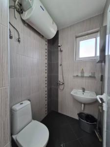 a bathroom with a toilet and a sink at Blue Summer in Obzor +45 photos