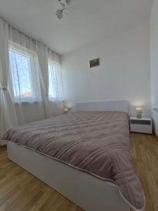 a bedroom with a large bed in a white room at Blue Summer in Obzor