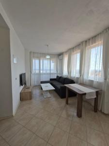 a living room with a couch and a table at Blue Summer in Obzor
