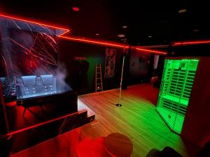 a room with a stage with a green and red light at La nuit nocturne in Bolbec