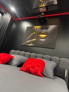 a bedroom with a bed with a picture on the wall at La nuit nocturne in Bolbec