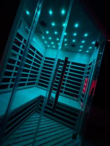 an empty boxing ring with blue lights on it at La nuit nocturne in Bolbec