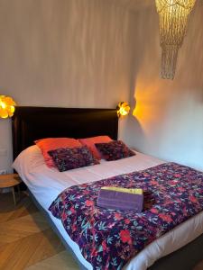 a bed with a blanket and a box on it at Appartement premium Hyper Centre in Ajaccio