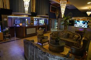 a lobby with couches and a tv and a bar at Safir Hotels Silivri in Silivri