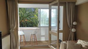 a bedroom with a glass door leading to a kitchen at Appartement à Anglet in Anglet