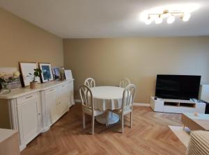 a living room with a table and a tv at Appartement à Anglet in Anglet