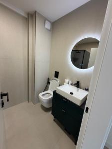 a bathroom with a toilet and a sink and a mirror at Mare e Monti in Bar +25 photos