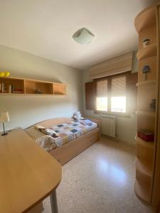 a small bedroom with a bed and a window at Cal Pelat Guimerà in Guimerá +25 photos