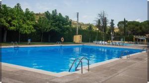 a large swimming pool with blue water at Cal Pelat Guimerà in Guimerá