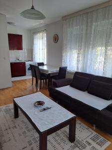 a living room with a couch and a table at Apartment in Pale in Pale