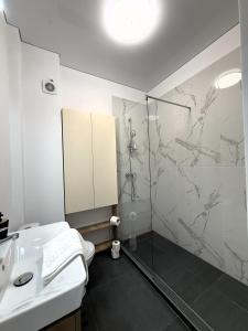 a bathroom with a shower and a sink at VIBE Apartments in Năvodari +59 photos