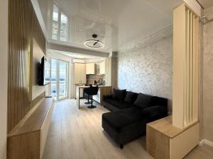 a living room with a couch and a table at VIBE Apartments in Năvodari