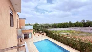 a swimming pool in the backyard of a house at villa Tarik with private pool in El Aïn