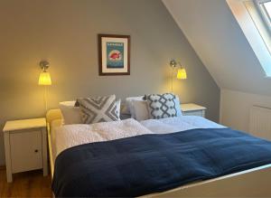 a bedroom with a bed with a blue blanket at Kajüthus Apartment 3 in Fehmarn