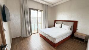 a bedroom with a bed and a large window at villa Tarik with private pool in El Aïn +45 photos