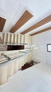a kitchen with white walls and a vaulted ceiling at villa Tarik with private pool in El Aïn