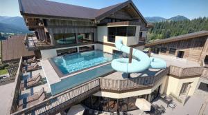 an aerial view of a house with a swimming pool at Schiefergut Family Resort Flachau in Flachau