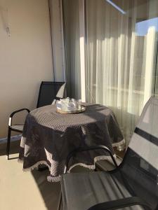 a table with a plate of food on it in a room at Modernes Appartement - ruhig, zentrumsnah, abendsonnige Loggia in Bad Füssing