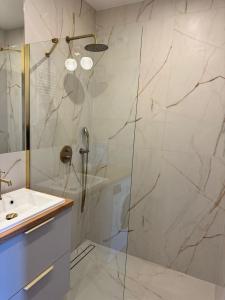 a bathroom with a shower and a sink at Pino SeaView I in Gdańsk