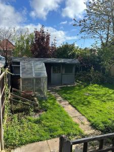 a greenhouse in the grass in a yard at Rehoboth place in Nottingham