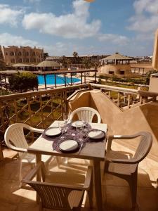 a table with plates and glasses on top of a balcony at Tropisal Apartamento in Santa Maria +18 photos