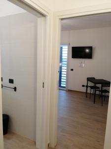 a door leading to a dining room with a table at Sea and Airport View in Fiumicino +7 photos
