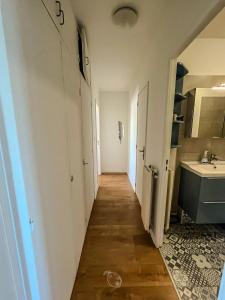 a hallway of a bathroom with a sink and a toilet at BayView in Saint-Brieuc