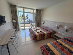 a hotel room with two beds and a table at Hotel Residence Holiday in Sirmione +107 photos