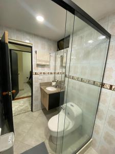 a bathroom with a toilet and a sink and a shower at fabuloso primer piso en envigado in Envigado +6 photos