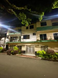 a white building with windows and balconies on a street at fabuloso primer piso en envigado in Envigado