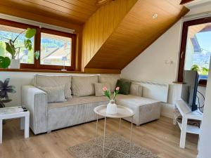 a living room with a couch and a table at Studio Lilly in Bohinj