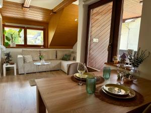 a living room with a table and a couch at Studio Lilly in Bohinj